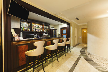 Hotel lounge bar with bottle shelfs and seats