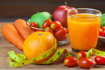 Healthy concept with mixed fruits and vegetables on wooden background