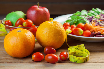 Healthy concept with mixed fruits and vegetables on wooden background