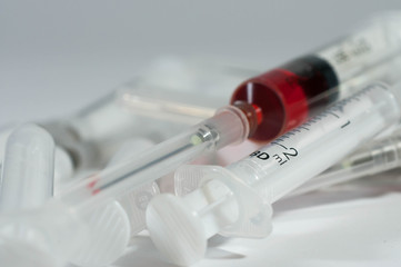 A bunch of used plastic syringe isolated on white, conceptual hospital waste image.
