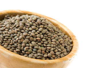 Lentils grain on wooden bowl isolated on white background