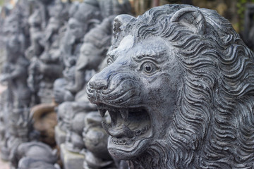 Stone sculpture of lion in the traditional art market of Ubud, Bali