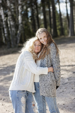 Portrait of two young females hugging