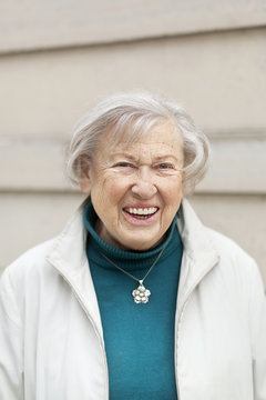 Portrait of smiling senior woman with grey hair
