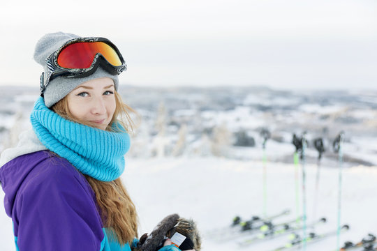 Smiling woman with ski goggles