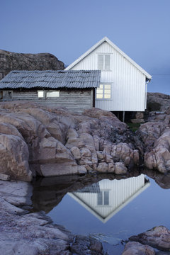 White house and cabin on rock cliff