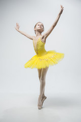 Young classical dancer on white background.
