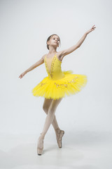 Young classical dancer on white background.