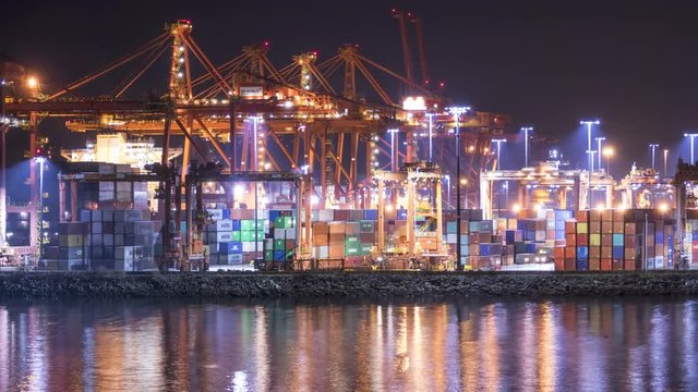 4K Timelapse of Shipyards and Docks at Night in Vancouver. Cargo loading onto boats in this industrial place.