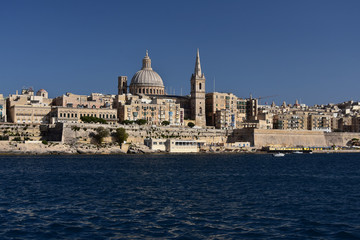 Fototapeta na wymiar Maltese capital Valletta seen from the see. Serene afternoon in the bay of Sliema