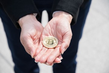 Close up, bitcoins are holding by business man's hands