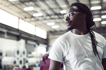Thoughtful blue collar worker wearing protective eyeglasses in steel industry