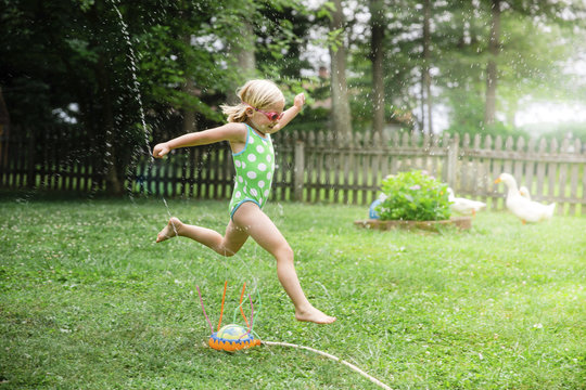 Side view of girl playing in backyard