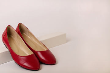 Female shoes of red color on a white background.
