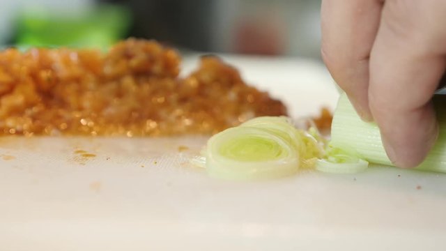 Sushi Chef Slices fresh Salmon on the sushi bar. Preparing of salmon tartar