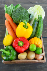 Raw vegetables on wooden table.