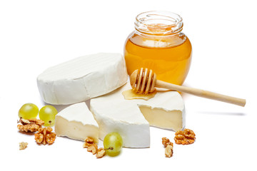Round brie or camambert cheese and honey jam on a white background