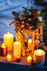 Wedding decor, candles in wooden flasks in the forest.