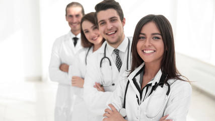 female doctor with group of happy successful colleagues