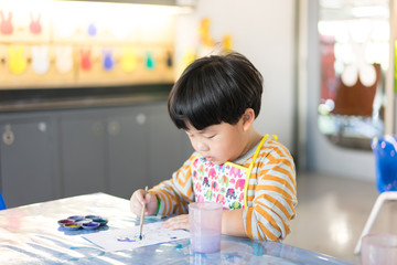 A boy is painting.