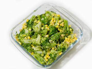 corn-grained broccoli salad on a transparent serving plate