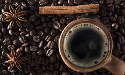 clay cup of coffee on the background of seeds