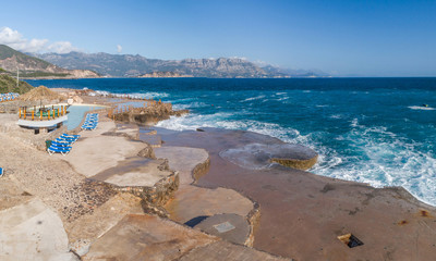 Aerial view of the coast of Montenegro. Storm waves on the Ploče beach.
