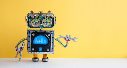 Service work maintenance concept. Robot handyman with hand wrench, silver pliers on yellow background. Copy space