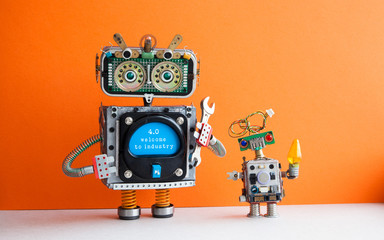 Industry 4.0 concept. Big IT specialist robot with hand wrench and small robotic cyborg. Welcome to the new economic future message on blue display. Orange wall background