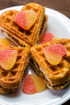 Cakes in the form of hearts are on a white plate.