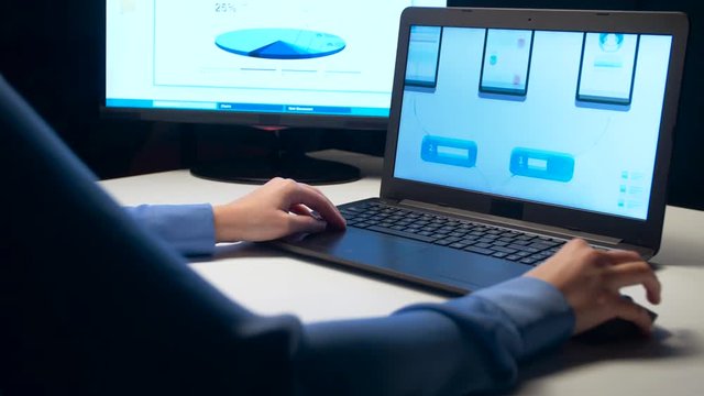 web designer with laptop working at night office