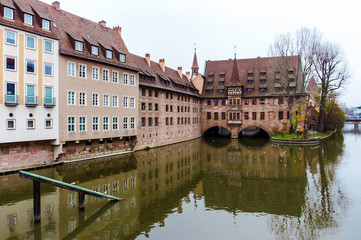 Nurnberg Landmark, Heilig-Geist-Spital or Hospice of the Holy Spirit in autumn, Nuremberg, Germany. View from the Bridge on the River Pegnitz Museum