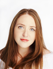 Beautiful young redhead woman with freckles portrait isolated on white