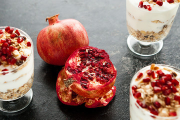 Pomegranate in the middle of home made desset on dark wooden background