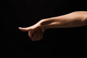 Obraz na płótnie Canvas Hand gestures - man pointing, isolated at black