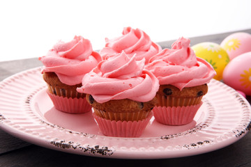 Tasty cupcakes on wooden background. Birthday cupcake in pink color