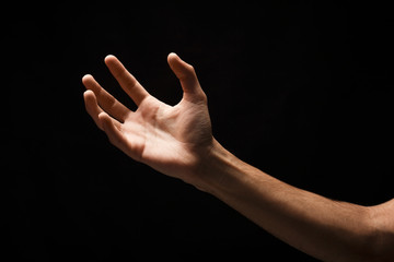 Taking hand isolated on black background