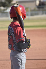 Youth baseball player with bat on shoulder