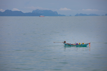 Fishermans in fishing boat in the blue sea, Thailand