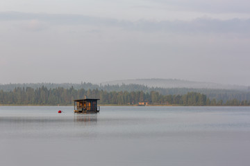 Floating sauna on the morning lake