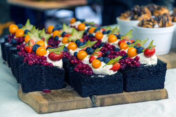 Lot of black cakes on farmer street market