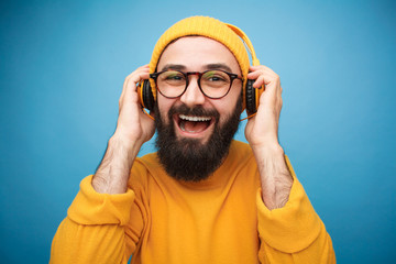 Cheerful bearded man enjoying music