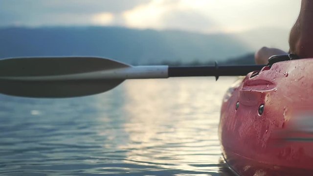Close up of kayaker sits in kayak and looks amazing sunset. slow motion. 1920x1080