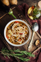 Asian Lagman soup with noodles and meat on a wooden board with olive oil and bread pita - 188433455