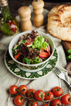 vegetable salad in Caucasian style with bread pita on wooden table