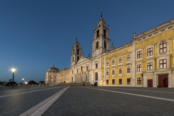 View of the Convent of Mafra at night in Mafra, Portugal; Concept for travel in Portugal and most beautiful places in Portugal