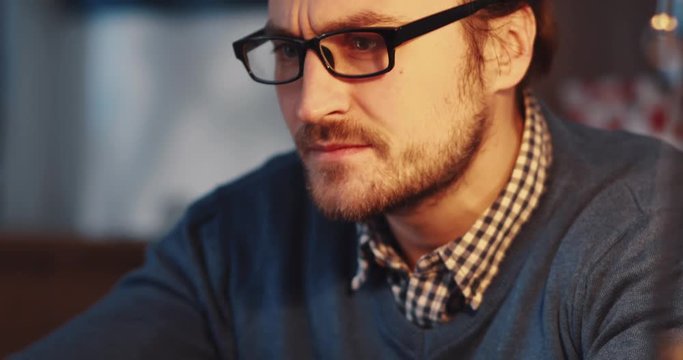 Close up view of angry businessman having problems with his device, clicking over and over again, checks the result, putts of the glasses and disappointed closes the laptop. Stress, troubles.