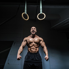 Fototapeta na wymiar Brutal strong athletic men bodybuilder trains in the gym