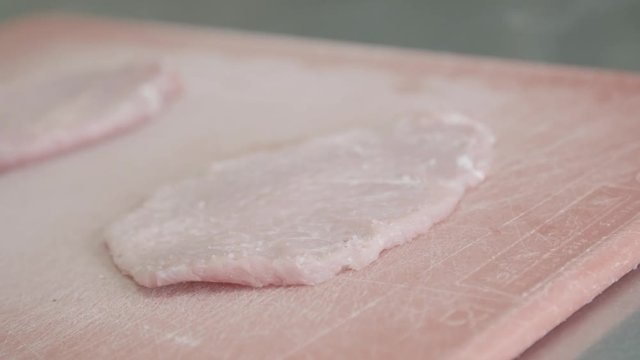 Pork tenderized on cutting board, close up