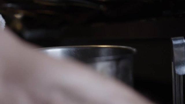 Close up, chef puts cloves of garlic into pot